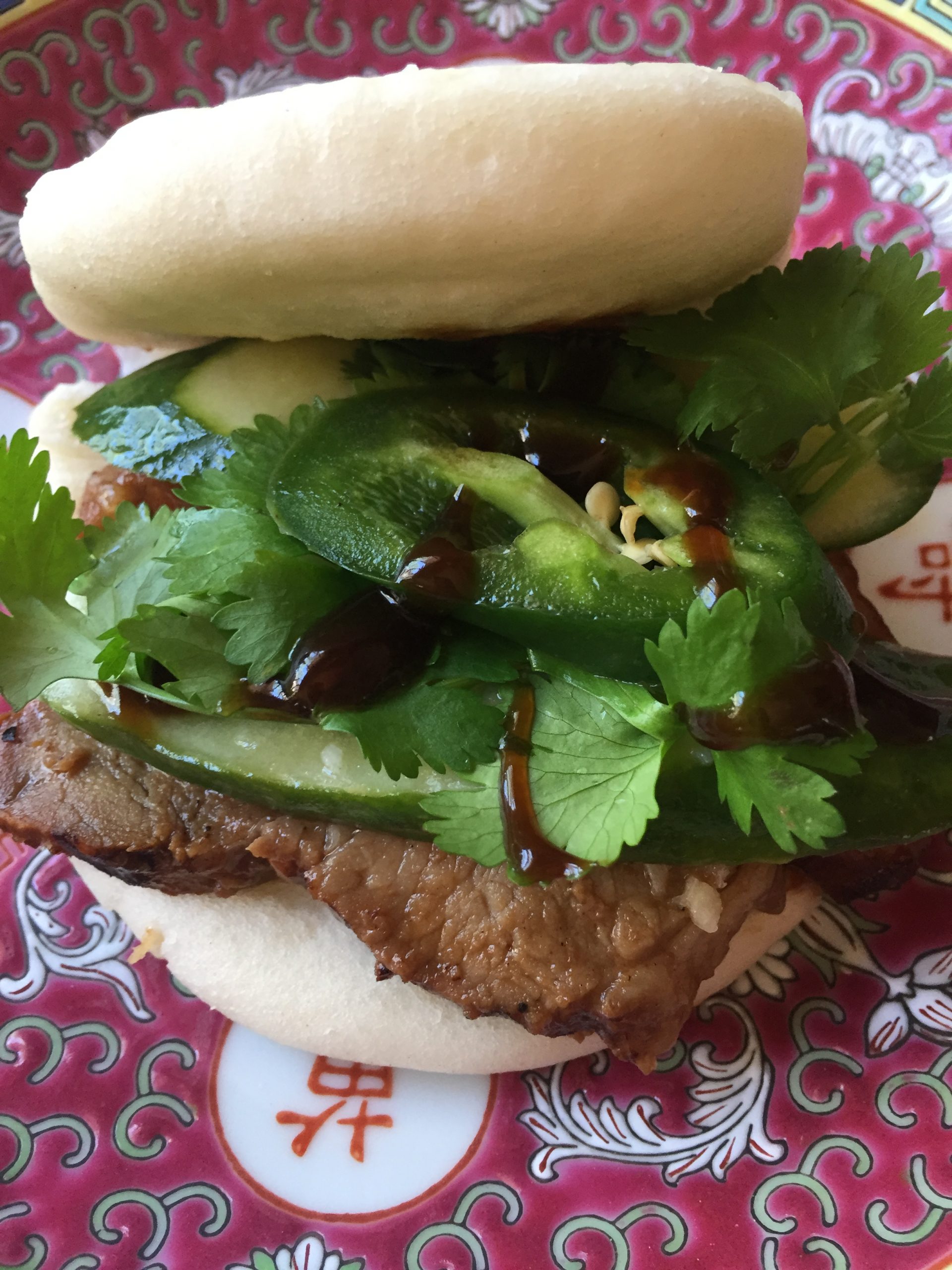 Chinese BBQ Pork Buns with pickled cucumber, cilantro, jalapeno and hoisin sauce.