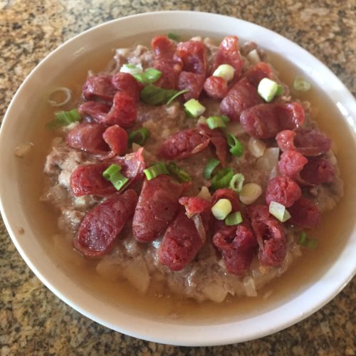 Chinese Steamed Pork with sausage sprinkled with chopped scallions