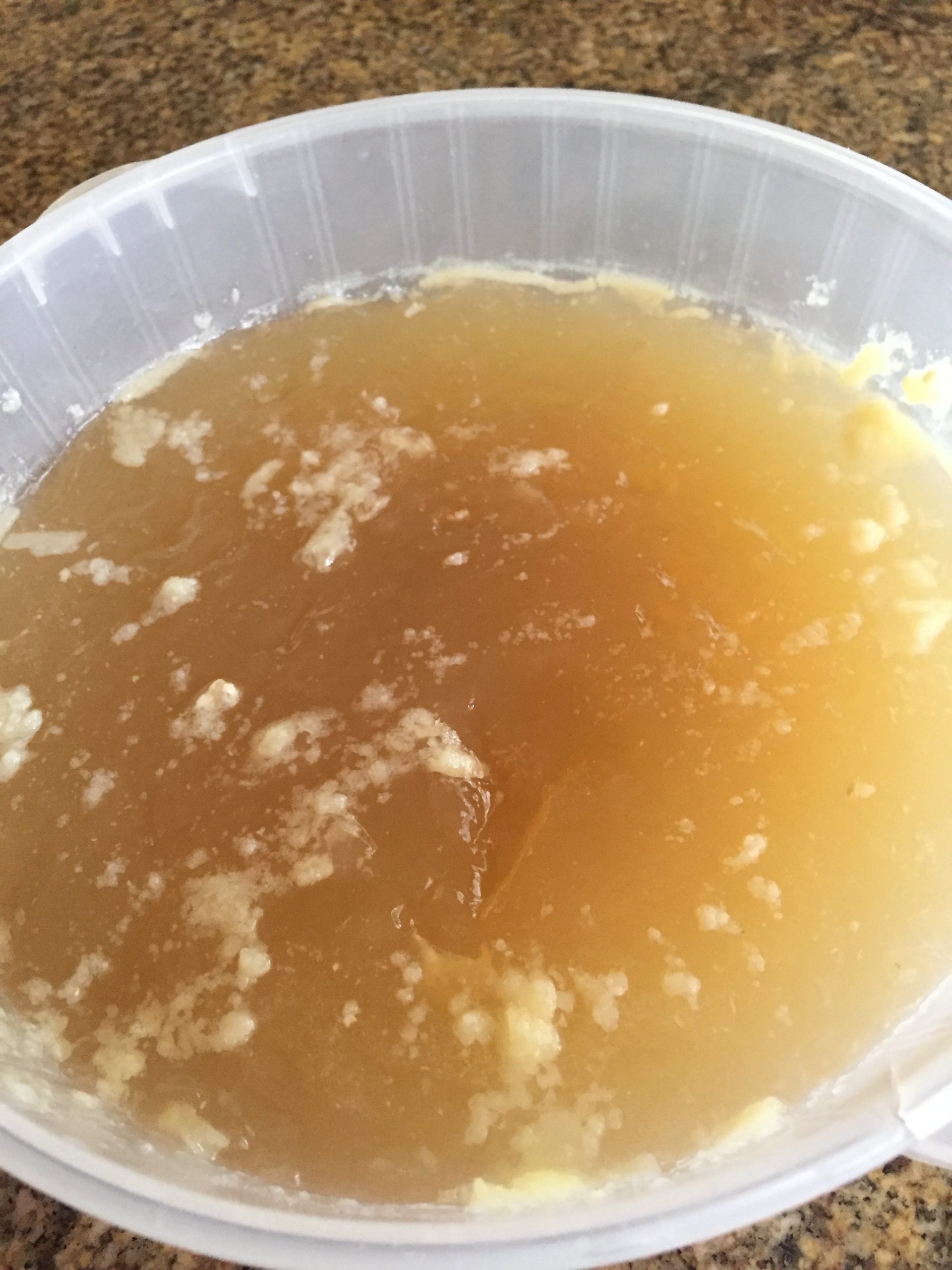 Cooled chicken broth with skimmed fat layer