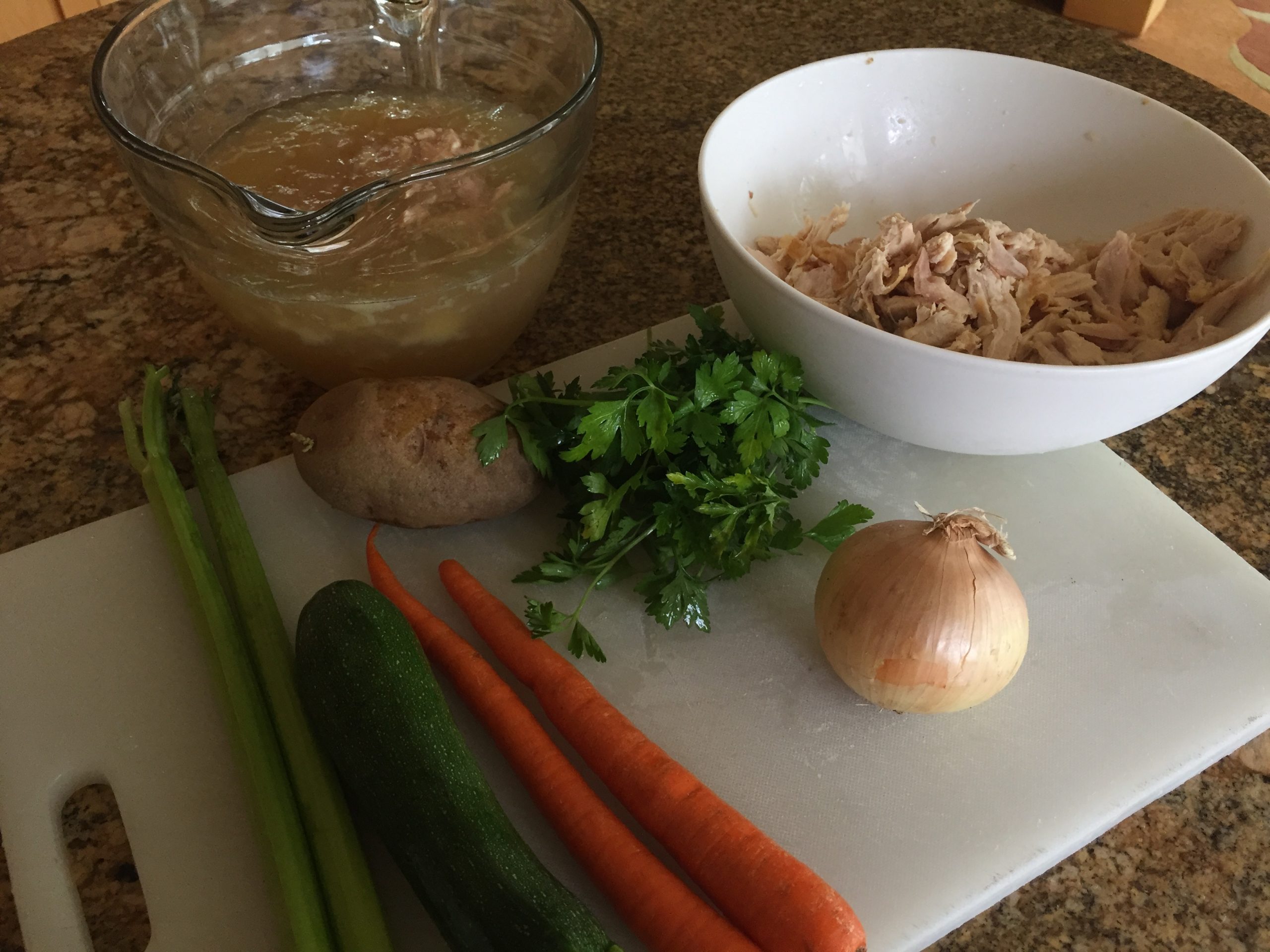 Shredded chicken, onion, parsley, potato, carrots, zucchini, celery, broth for chicken soup with vegetables