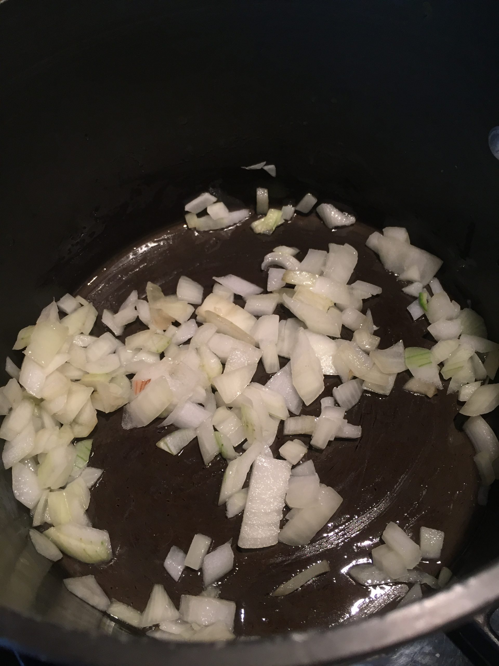 Raw chopped onion in saucepan