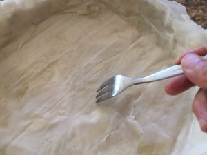 Poking holes with fork in phyllo pastry