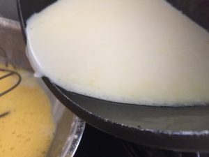 Add warmed milk to egg mixture