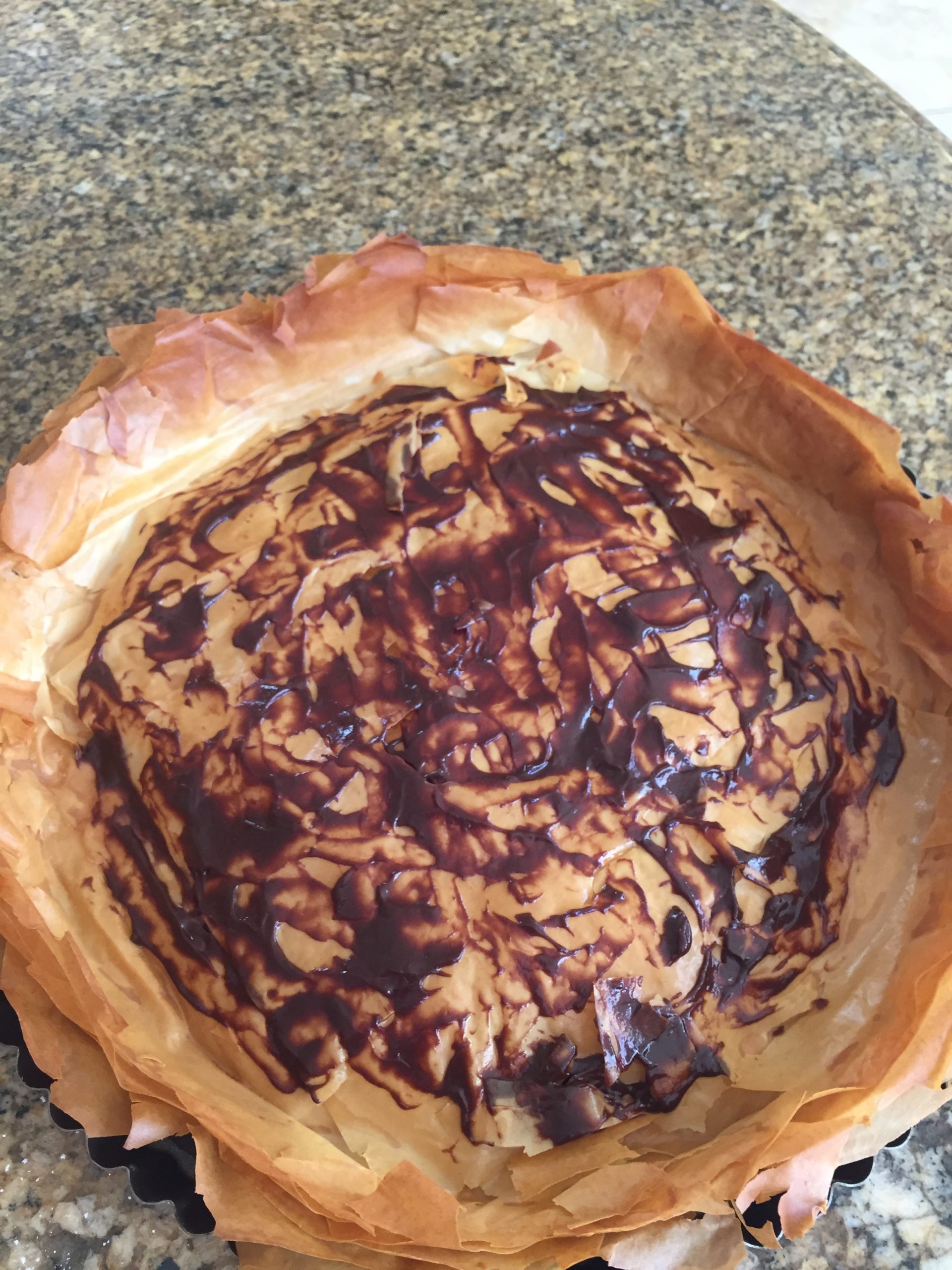 Lightly coated chocolate sauce on phyllo pastry base for tart