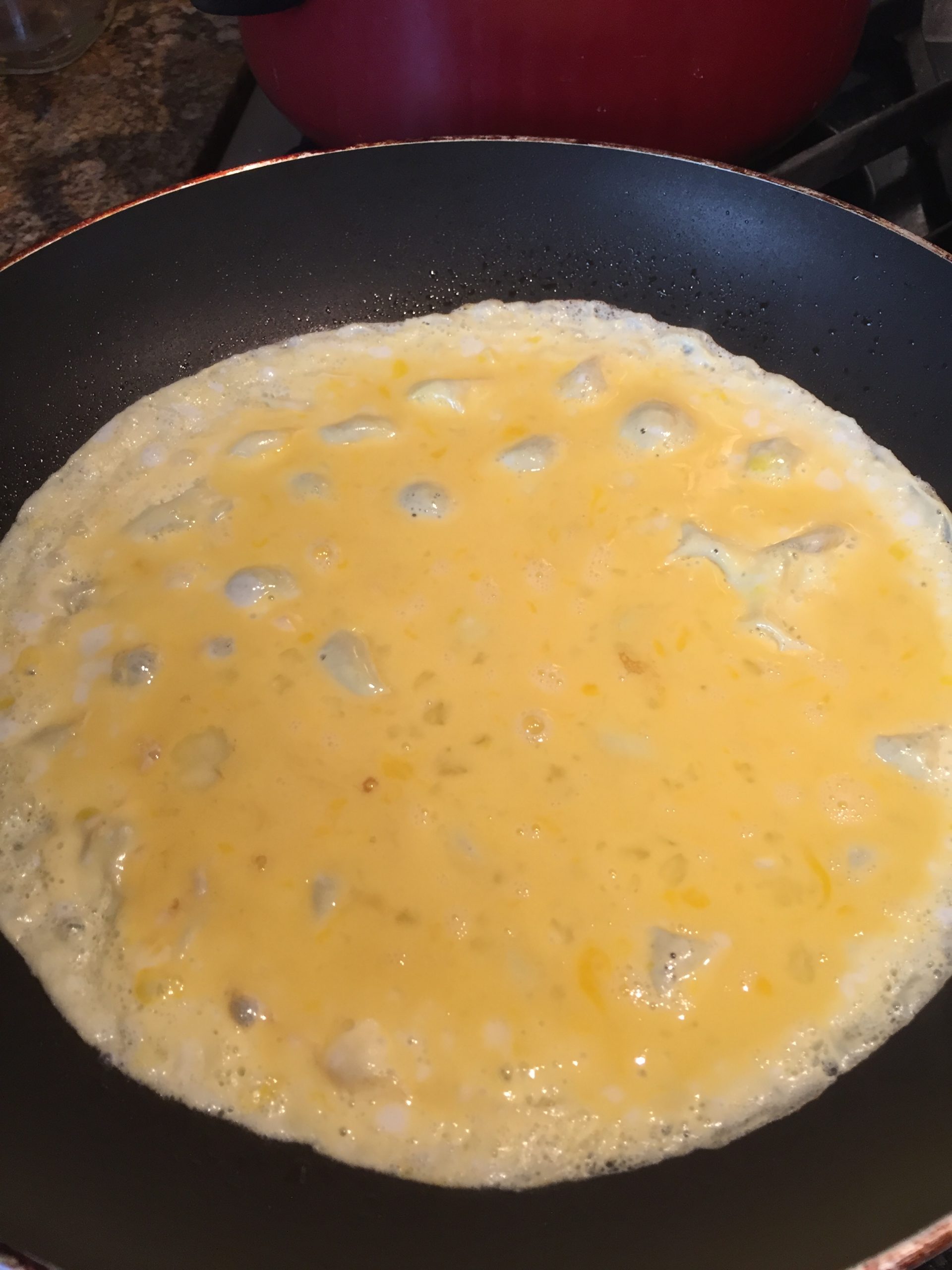 Raw egg in the pan for omelette