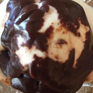 Gooey chocolate fudge sauce over ice cream