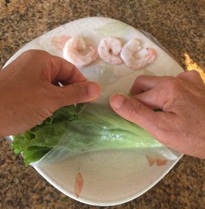 Roll the bottom end of your lettuce and rice wrapper.