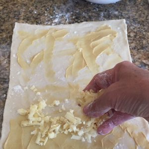 Spread dijon mustard and cheese onto the pastry.