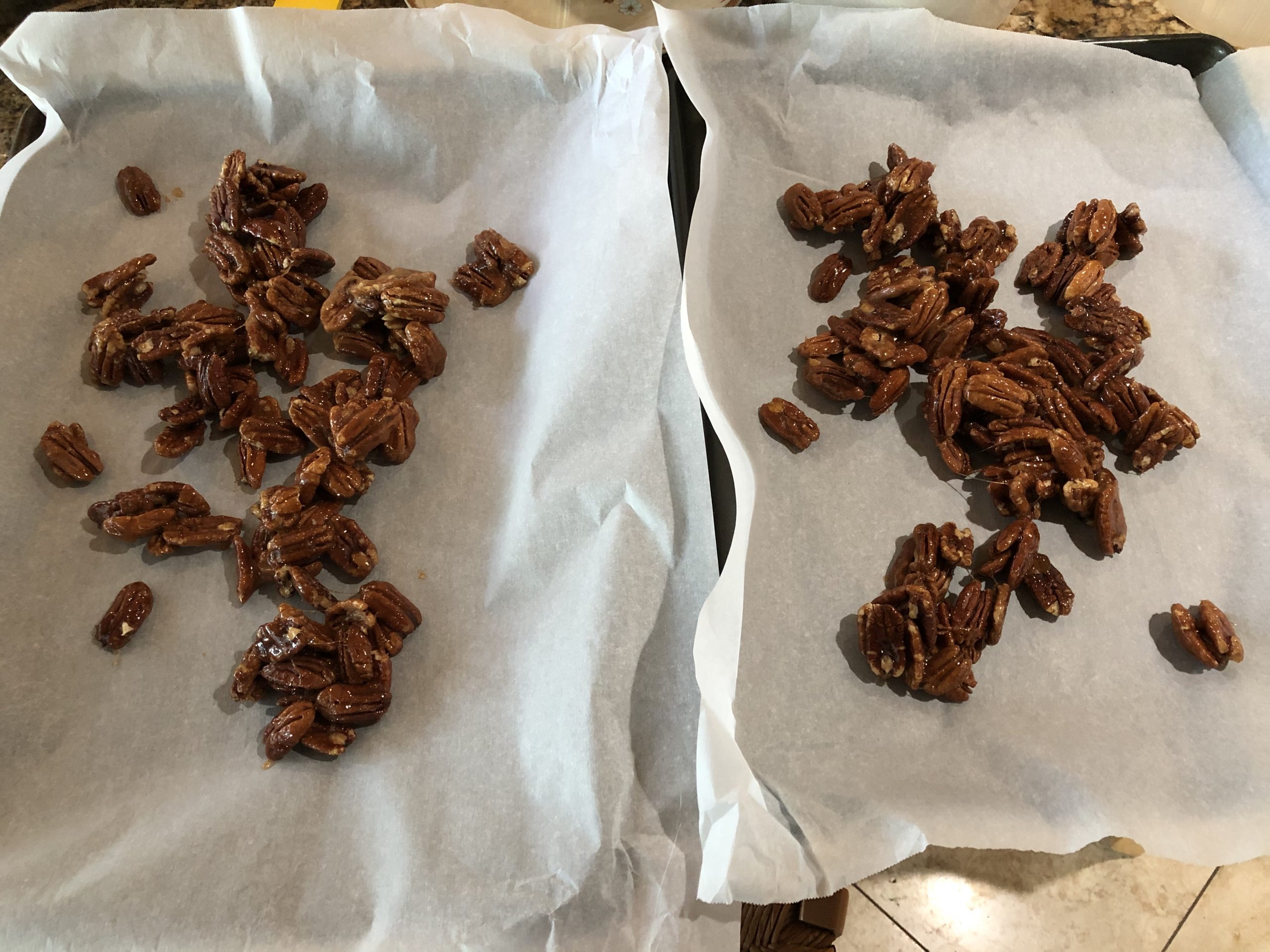 Divide pecans onto 2 baking trays