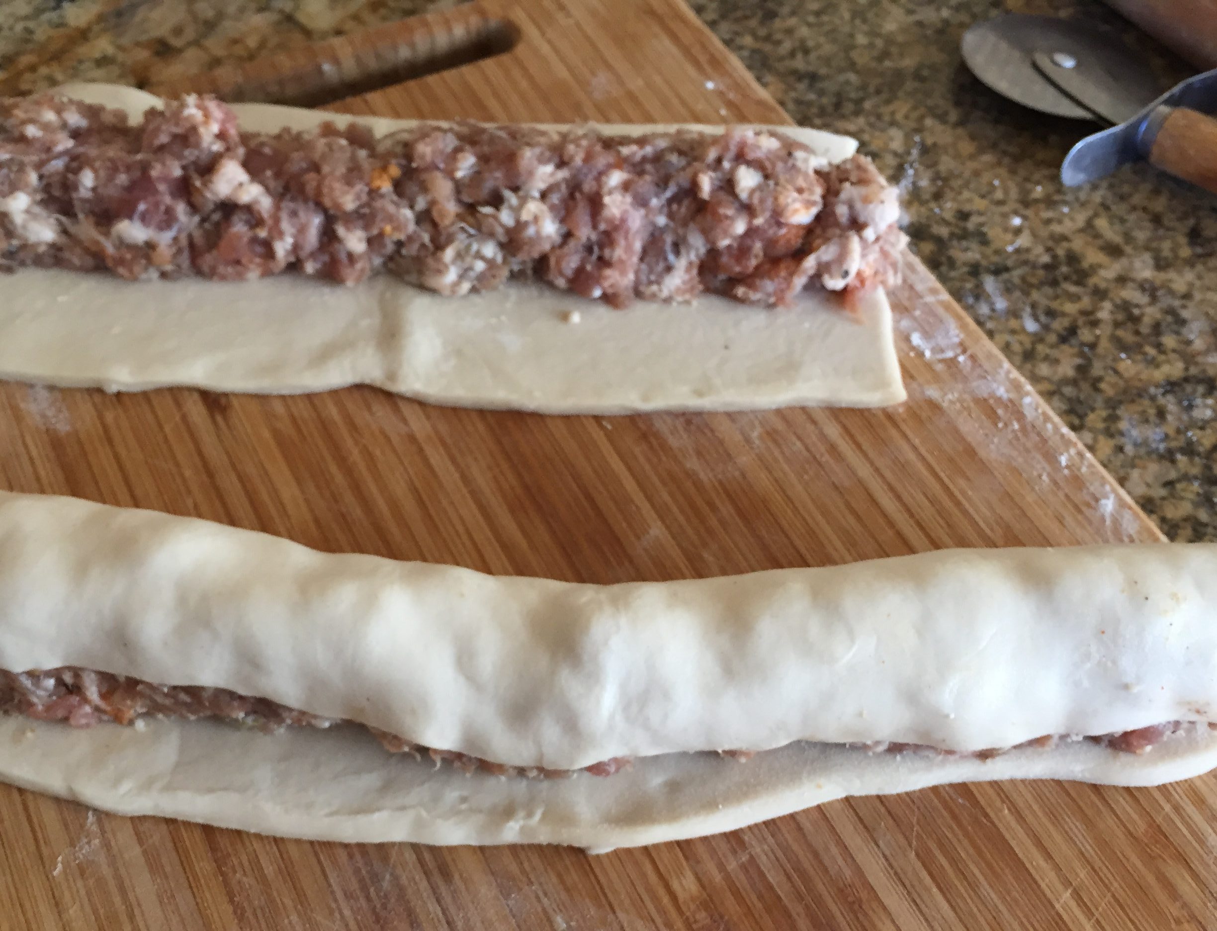 Pull puff pastry over half of sausage