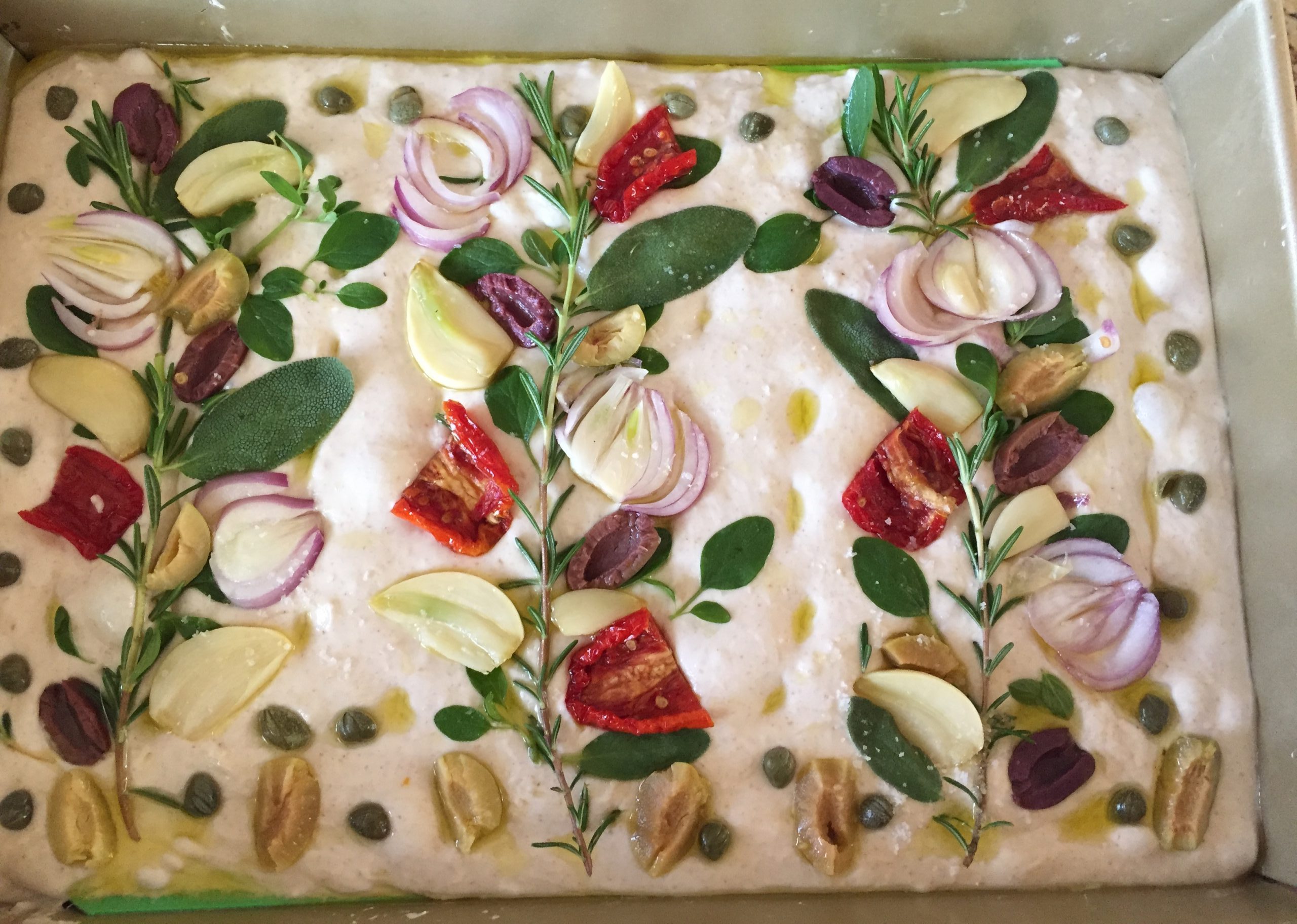 Uncooked focaccia with toppings