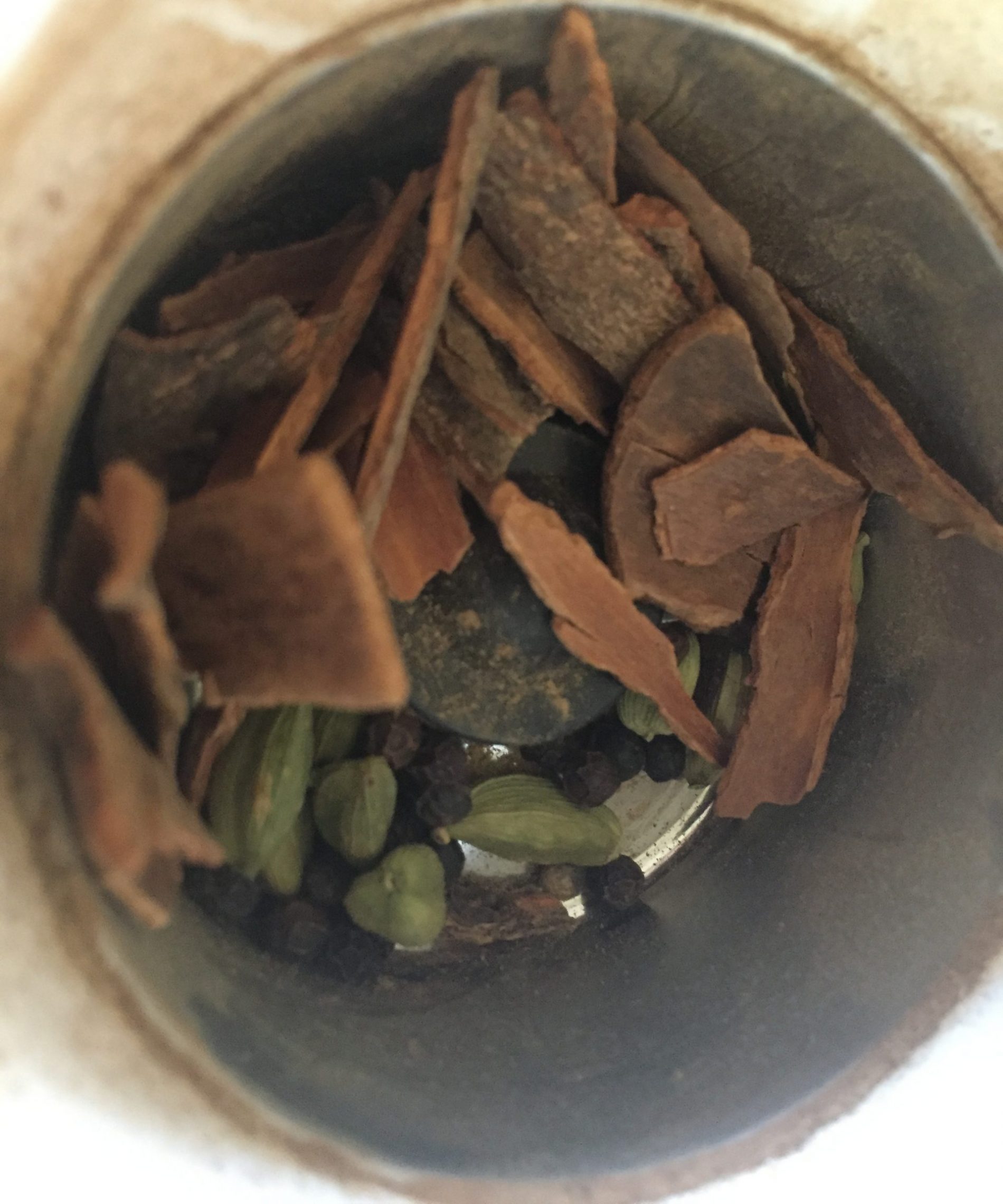 Whole chai spices in coffee grinder