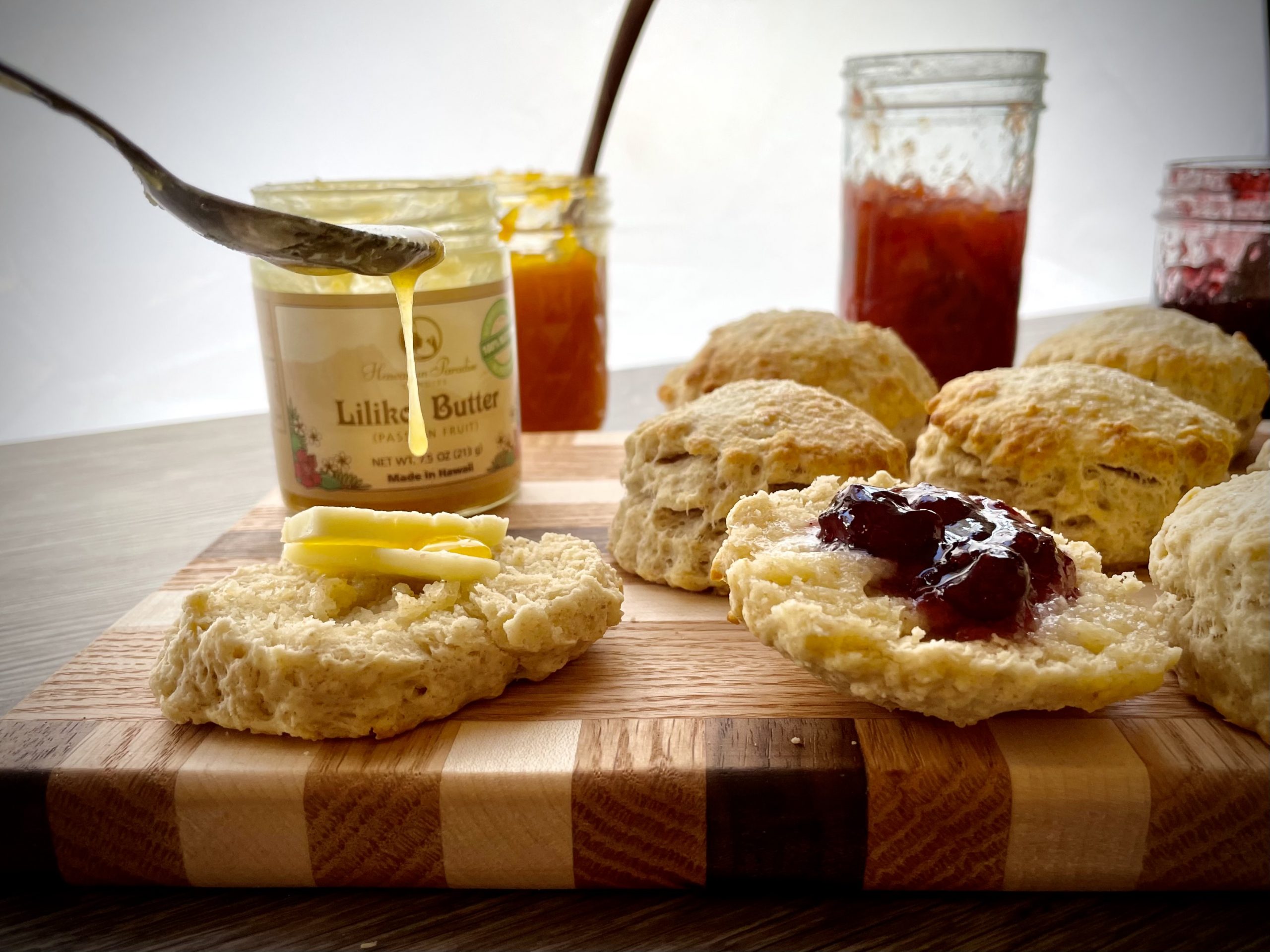 Scones served with butter and fruit preserves.