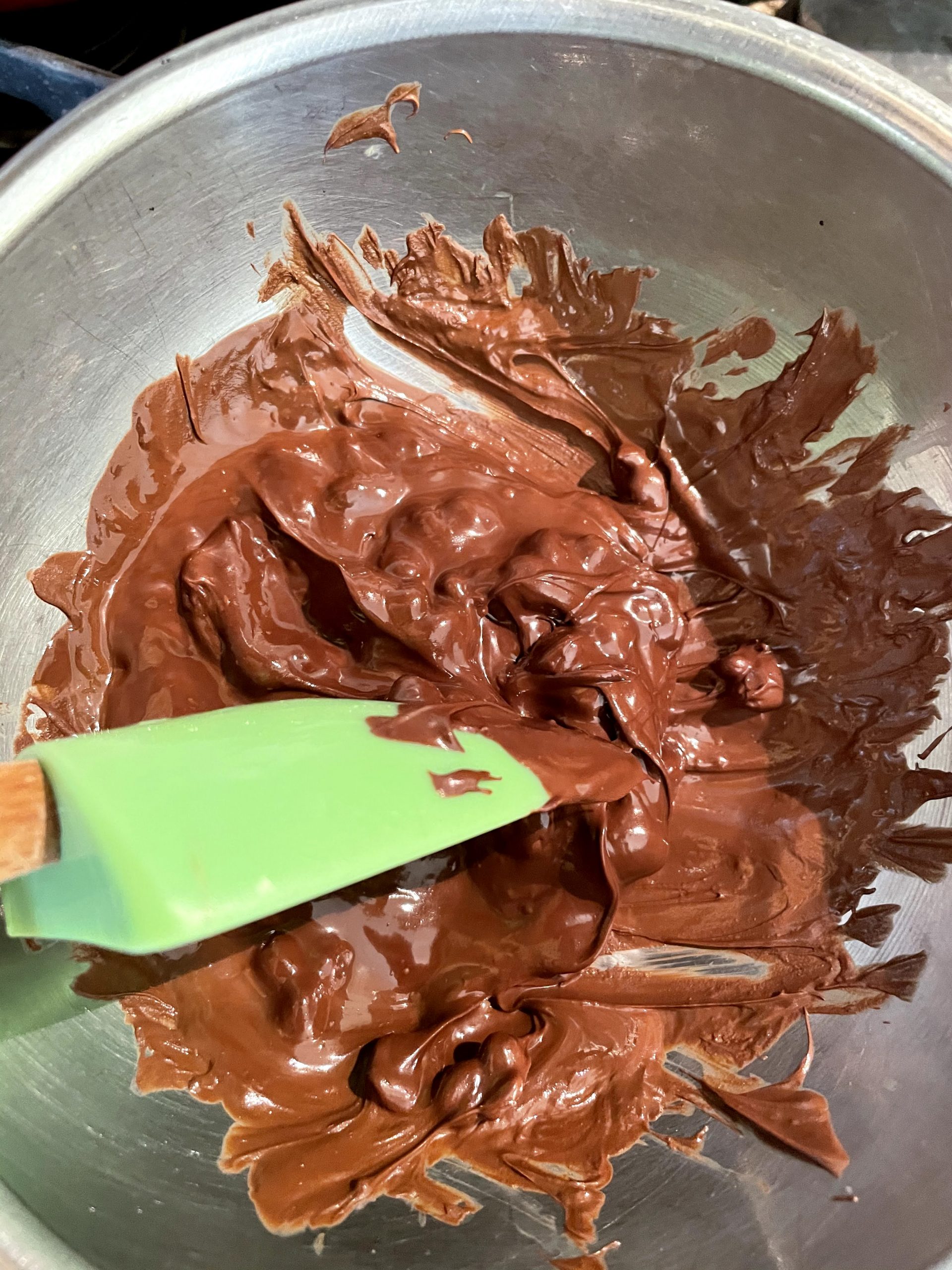 Use spatula to stir melted chocolate.  