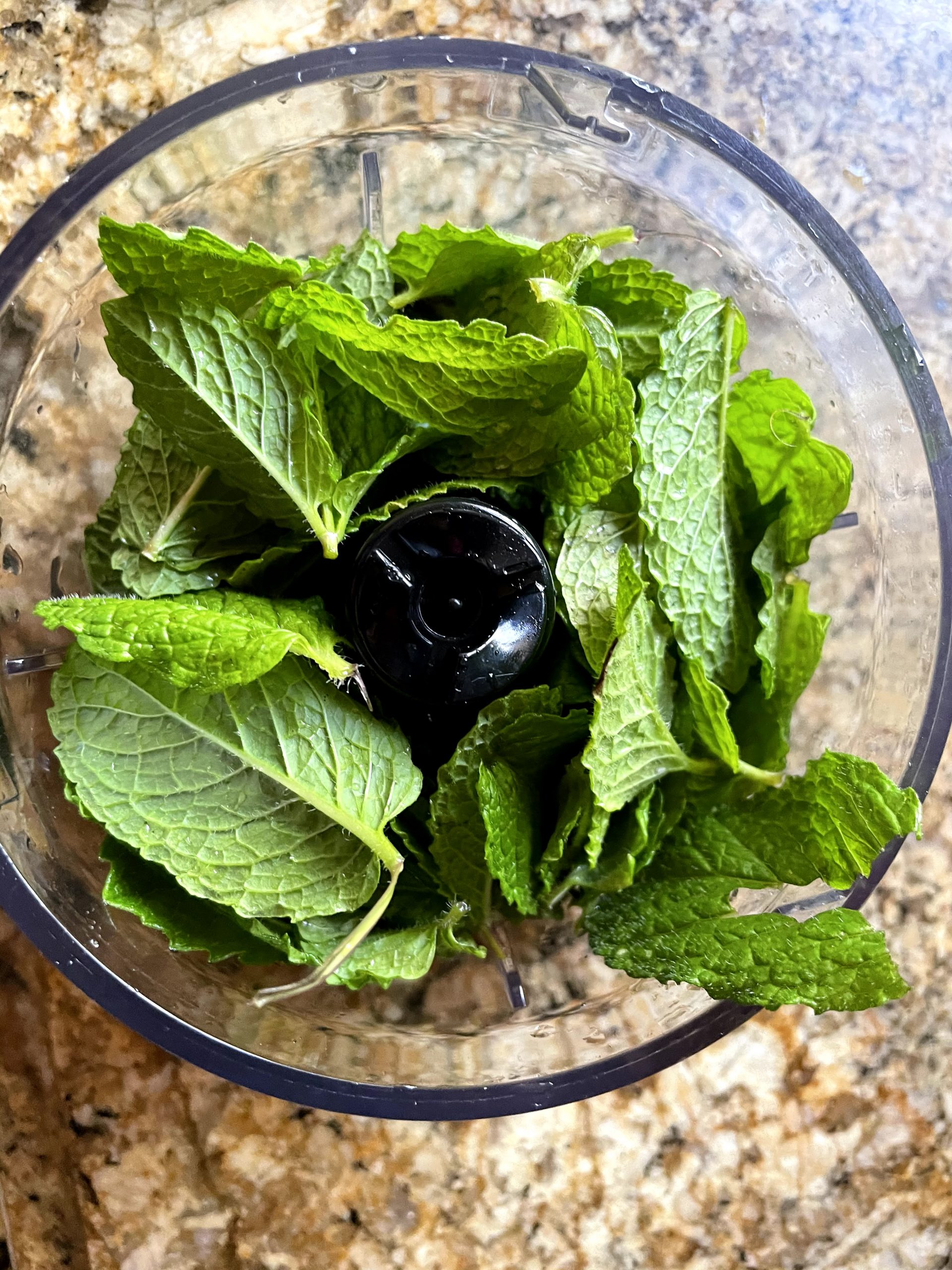Use a hand blender for chopping mint for vibrant mint sauce.