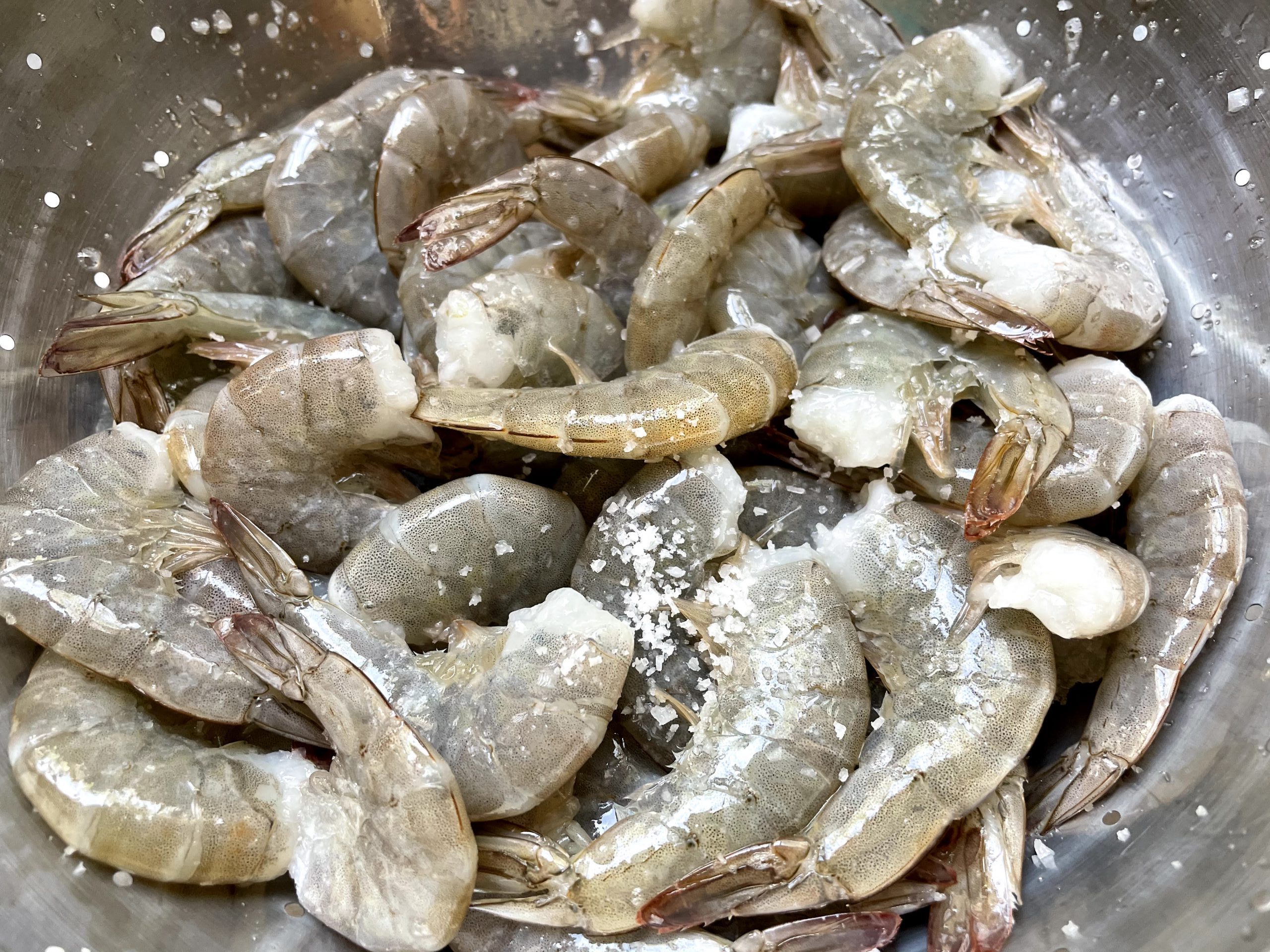 raw shrimp sprinkled with coarse salt.