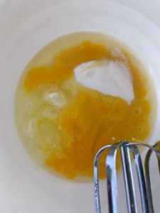 Mix sugar, eggs and extract for clafoutis
