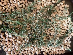 Raw rosemary on cashews.