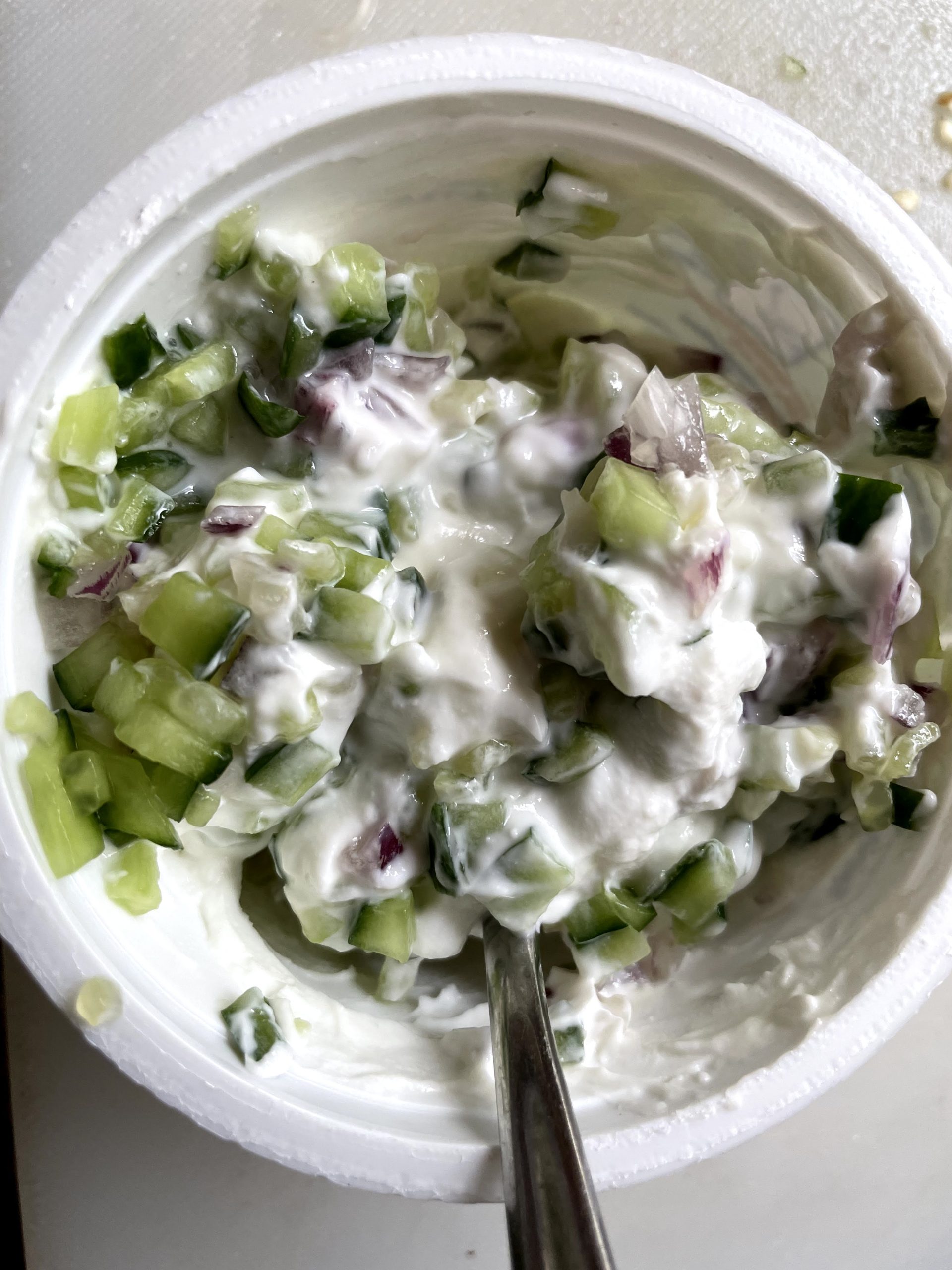 Mix yoghurt with chopped onion and cucumber