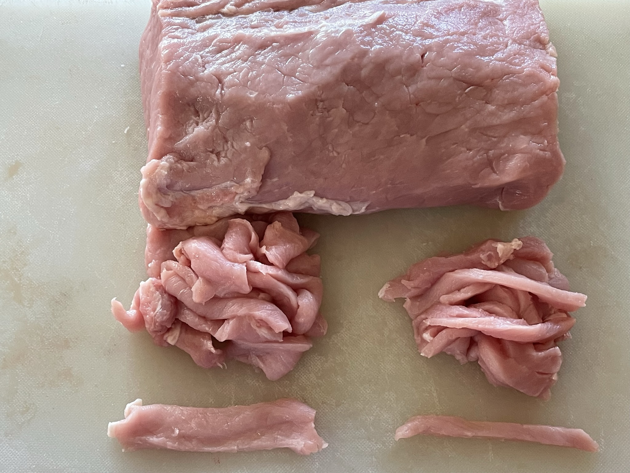 Pork loin cut into slices and strips.