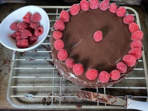 Decorate torte with raspberries.