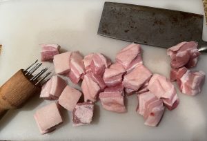 Cubed and tenderized pork belly