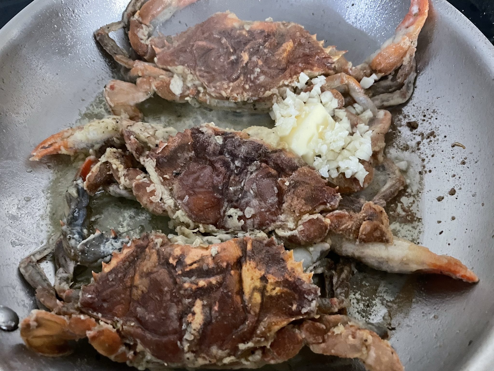 Add butter and chopped garlic after flipping the crabs.