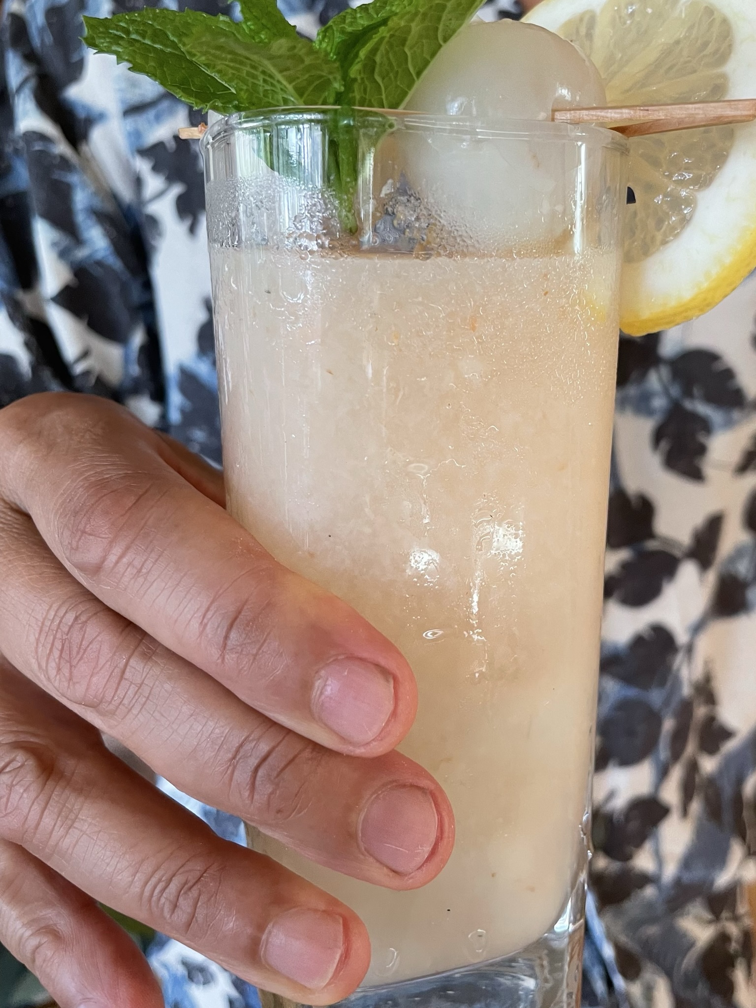 Holding lychee lemonade drink