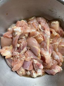 Marinate boneless chicken thigh pieces.