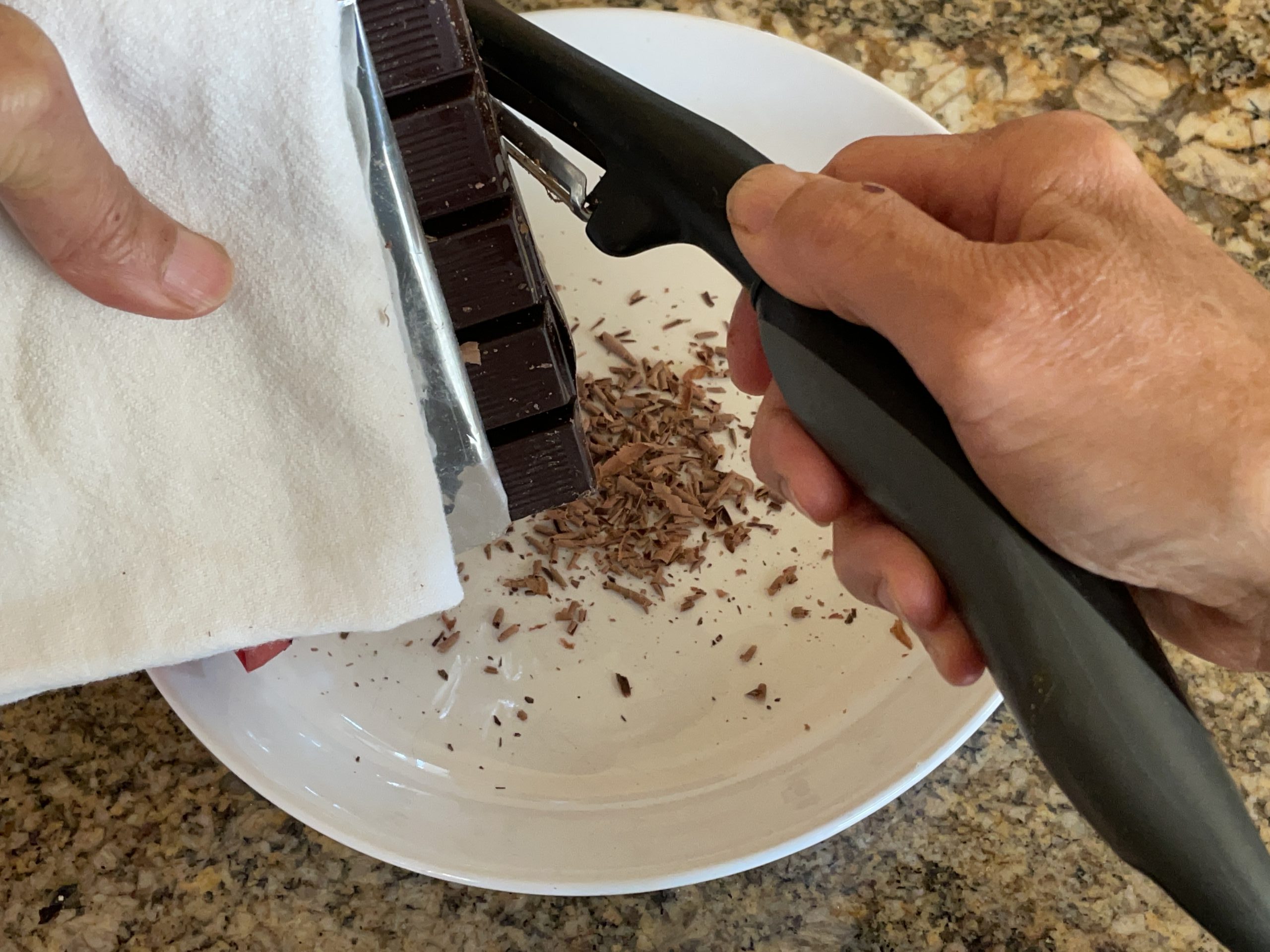 Shaving a bar of chocolate.