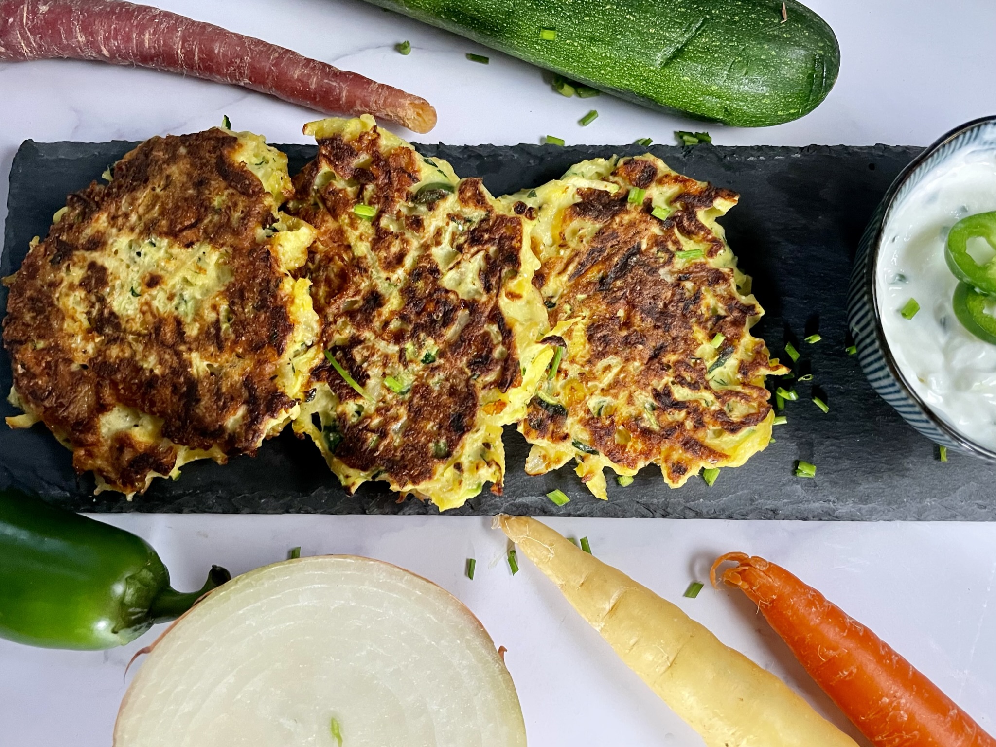 High protein vegetable patties with chive yoghurt dip.