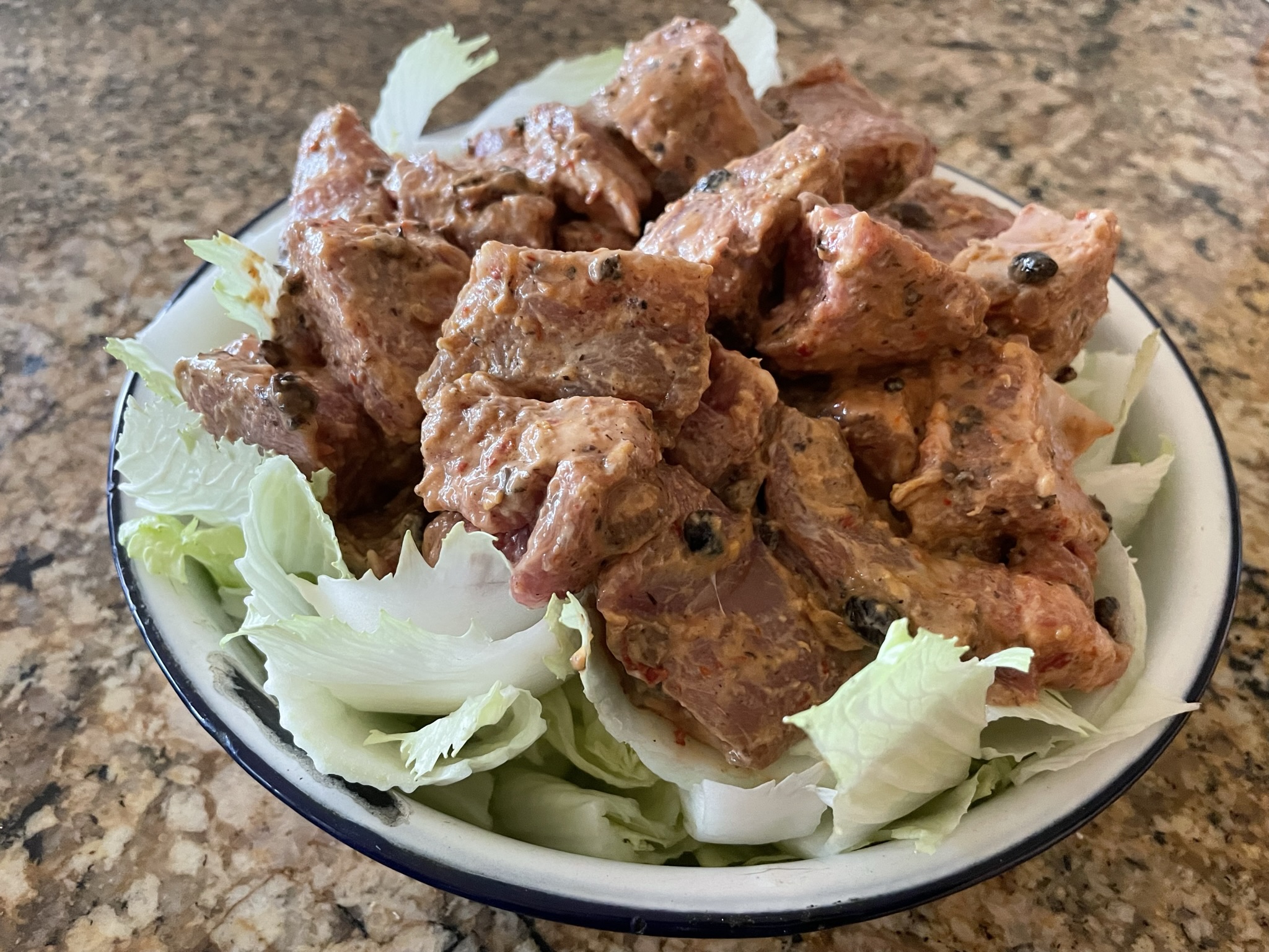 Place marinated pork ribs on top of napa cabbage pieces.