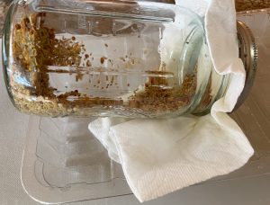 Angle canning jar to allow water to drain onto a tray.