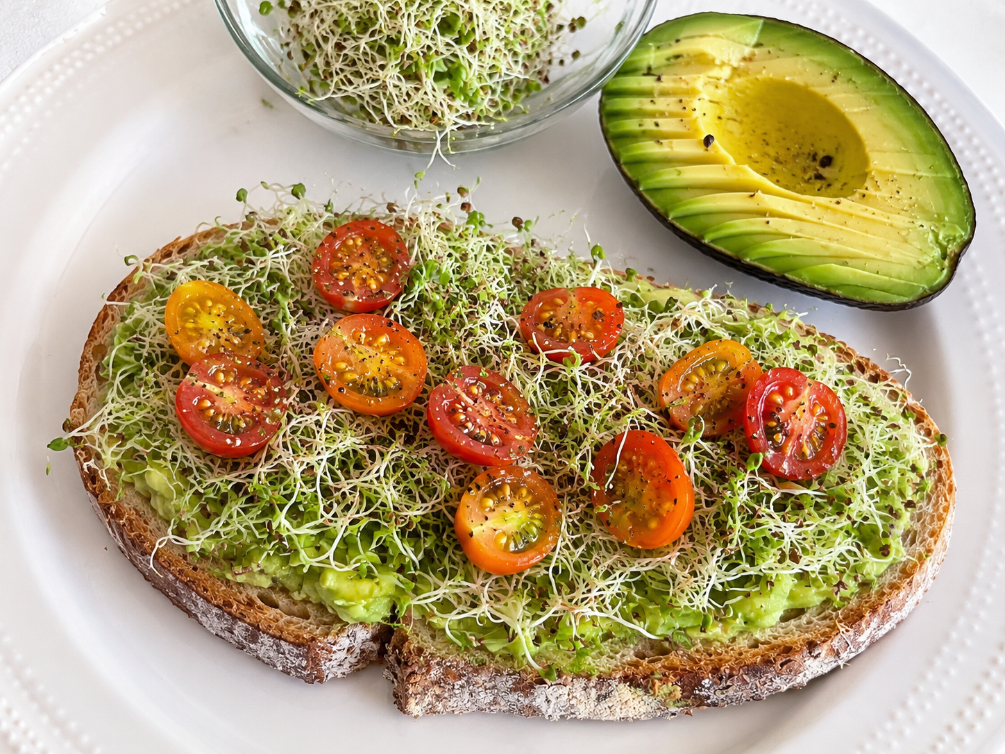 Avocado toast with home-grown tomatoes and sprouts